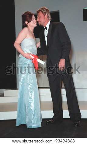23MAY99: French actor JOHNNY HALLYDAY with actress EMILIE DEQUENNE who tied for Best Actress at the 52nd Cannes Film Festival.  Paul Smith / Featureflash