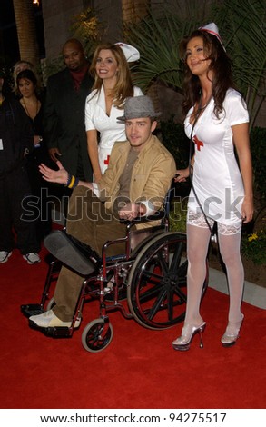 JUSTIN TIMBERLAKE of 'NSync - with nurses to help him due to his broken foot - at the 2002 Billboard Music Awards at the MGM Grand, Las Vegas. 09DEC2002