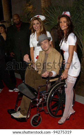 JUSTIN TIMBERLAKE of 'NSync - with nurses to help him due to his broken foot - at the 2002 Billboard Music Awards at the MGM Grand, Las Vegas. 09DEC2002