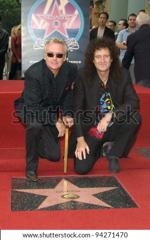 QUEEN stars ROGER TAYLOR (left) & BRIAN MAY on Hollywood Boulevard where the rock group was honored with the 2,207th star on the Hollywood Walk of Fame. 18OCT2002.   Paul Smith / Featureflash