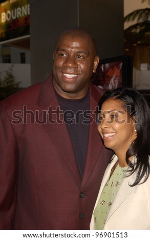 Basketball star EARVIN MAGIC JOHNSON & wife at the world premiere, in Hollywood, of The Bourne Supremacy. July 15, 2004