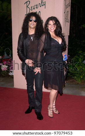 Feb 12, 2005; Beverly Hills, CA: Guns n\' Roses star SLASH & wife at record mogul Clive Davis\' Annual pre-Grammy party at the Beverly Hills Hotel.