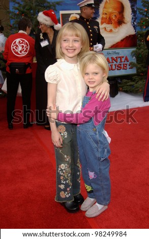 Actress sisters DAKOTA FANNING (left) & ELLE FANNING at the world premiere of The Santa Clause 2, at the El Capitan Theatre, Hollywood. 27OCT2002.   Paul Smith / Featureflash