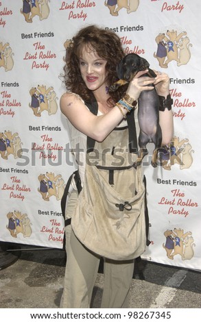 Actress DANA DAUREY & dog at the Best Friends Lint Roller Party at Santa Monica Airport, California. The event was held to benefit the Best Friends Animal Sanctuary. march 2003