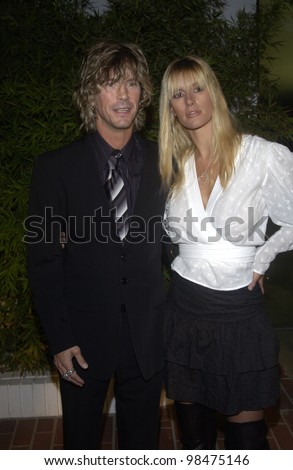 Guns \'n\' Roses star DUFF McKAGAN & wife SUSAN at the opening of designer Stella McCartney\'s first Los Angeles store. Sept 28, 2003  Paul Smith / Featureflash