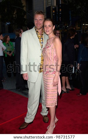 Director RENNY HARLIN & girlfriend at the premiere of his new movie Driven, at Manns Chinese Theatre, Hollywood. 16APR2001.    Paul Smith/Featureflash