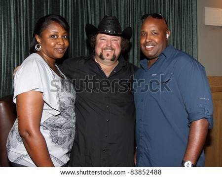 8-16-11 Athens, GA Colt Ford with Athens police officer Tony Howard and his wife, Shirlisa. Country artist Colt Ford rounded up his friends to hold a benefit for the family of Elmer 