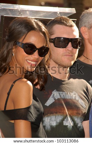 Zoe Saldana and Sam Worthington at the induction ceremony for James Cameron into the Hollywood Walk of Fame, Hollywood Blvd, Hollywood, CA.  12-18-09