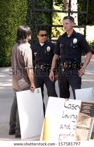 Police officers and protester at a protest involving Casey Kasem\'s children, brother and friends who want to see him but have been denied any contact,  Private Location, Holmby Hills, CA 10-01-13