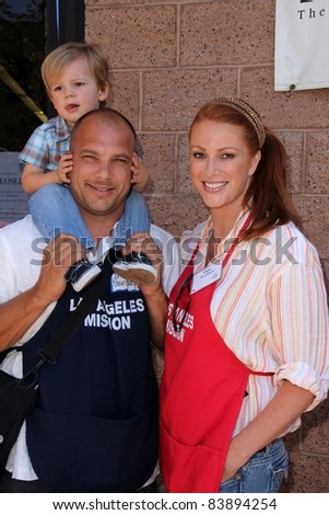 Angie Everhart and family at the Skid Row Block Party at the Los Angeles Mission, Los Angeles, CA. 08-27-11