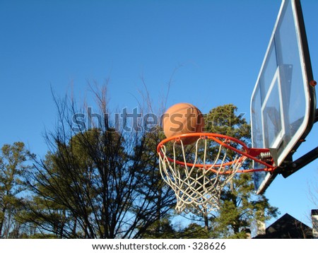 A basketball falling into the hoop for a three-pointer