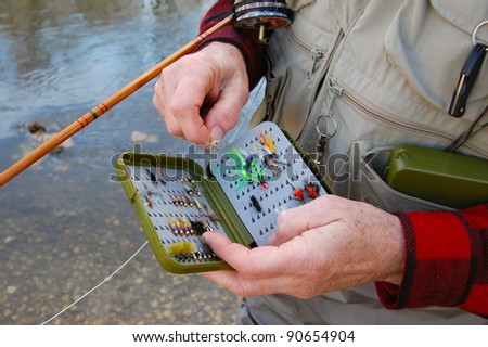 Fly Fisherman Closeup with Flies in Tackle Box