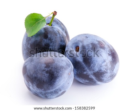 Group of plums with leaf isolated on white