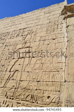 Hieroglyphic carvings on the wall of an ancient egyptian temple