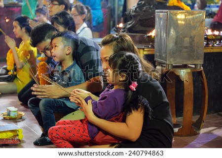 BANGKOK, THAILAND - DEC 27,2014 Unidentified family is praying in joss house at Houay Kwang intersection. This place is very famous. Tourist can visit by taking MRT to  Houay Kwang station.