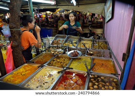 BANGKOK, THAILAND - DEC 27,2014 Unidentified woman is selling food on sidewalk  at Houay Kwang intersection. This area is very famous. Tourist can visit by taking MRT to  Houay Kwang station.
