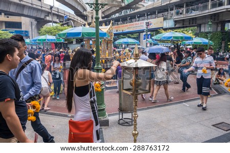 Bangkok, Thailand - June 19, 2015 Unidentified tourist woman prepares incenses to worship The Lord Brahma Shrine at Grand Hyatt Erawan Hotel.
