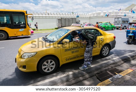 Bangkok, Thailand - Aug 10, 2015 Unidentified tourist is asking for the place to go with a taxi driver in front of The Grand Palace