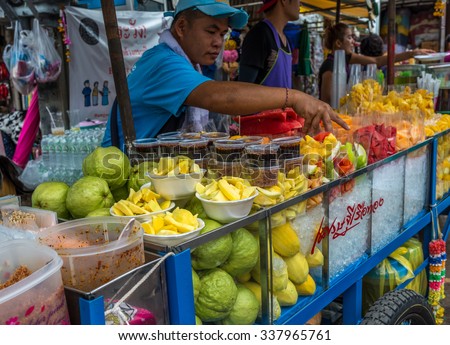 Bangkok, Thailand - Nov 7, 2015 Unidentified man is selling fruits at Chatuchak, the biggest weekend market in South East Asia.