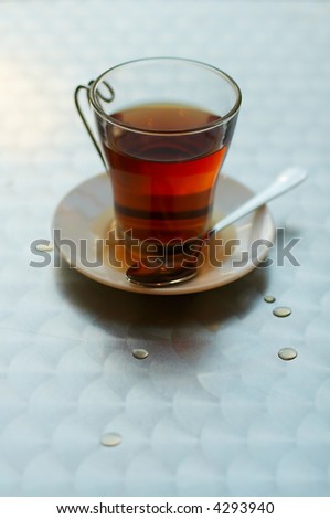 Tea cup with hot spilt tea