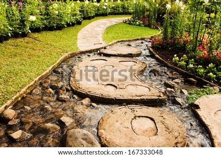 Landscape garden design. The path in the garden with pond in asian style