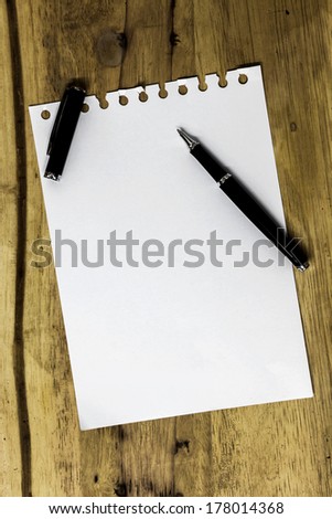 note paper and pen on wood texture background with copy space