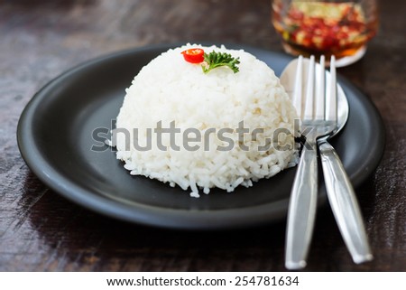cooked rice with a spoon and fork on dish