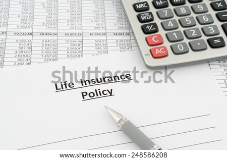 life insurance policy with numbers, calculator and pen
