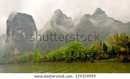 Low-Lying Clouds Shroud Limestone Outcroppings on a Drizzly Day - Li River, Guilin, China