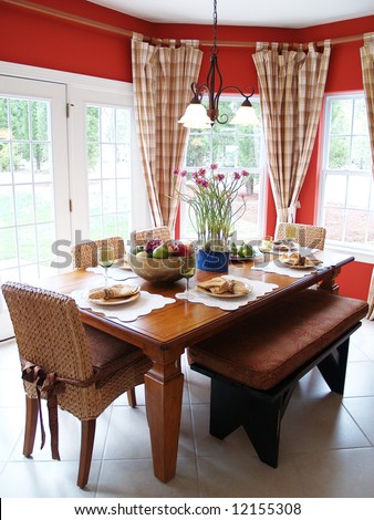 A rustic table set for a meal in a bright breakfast room