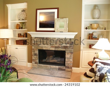 Stone fireplace in a modern living room with a white painted wooden mantle. Artwork has been replaced with art that I own the copyright to.