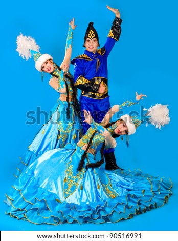 A guy and two girls in the Kazakh national costumes