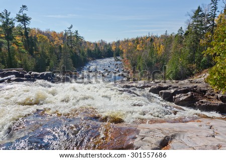 Cascading water over rocks in Superior Lake Provincial park, Canada