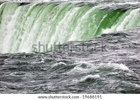 Blue-green water, falling down from Niagara falls.