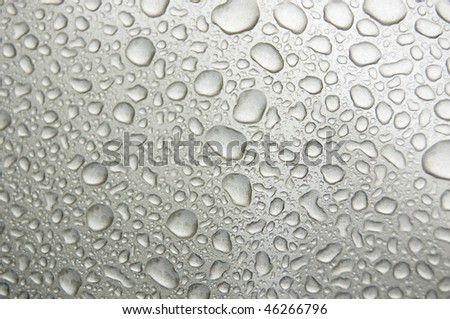 Gray rain drops on a car window