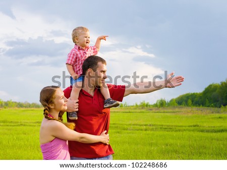 Happy family looks into the distance during leisure time in nature