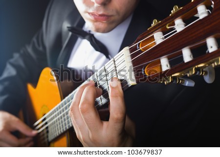 Playing the guitar. Musical instrument with performer hands