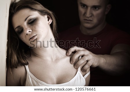 Crying woman with menacing man