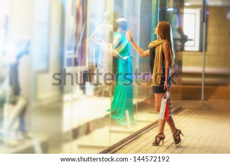 Beautiful Woman Carrying Many Shopping Bags On A City Street