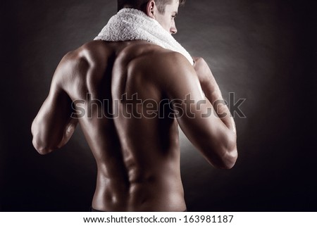 Young man after training on dark background Young man after training on dark background