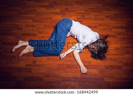 Girl lying on the floor in an empty room