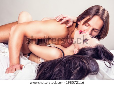 Couple beauty sexy lovers in bed on white background
