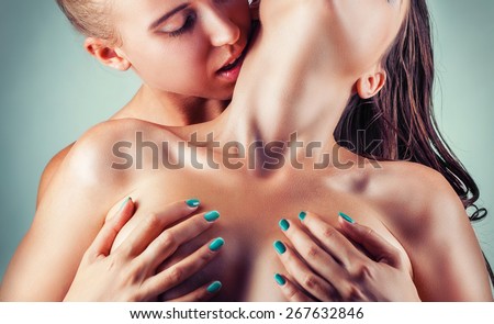 Sensual embrace with kisses. Two beautiful sexy lesbian women