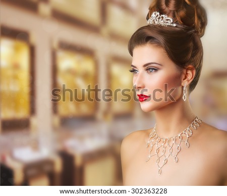 Portrait of a beautiful woman with makeup and elegant hairstyle on background jewelry store