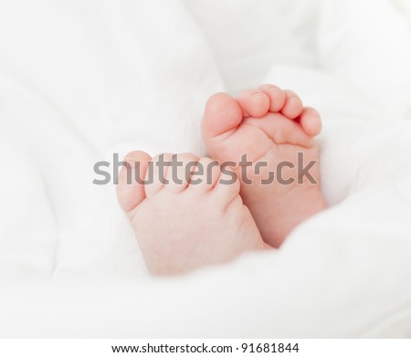 Cute little baby feet in white blanket