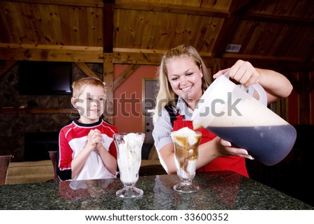 A mom and child make root beer floats