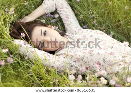 Beautiful girl lying on the grass.
