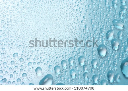Various sizes water drops. Water drops on shining background.