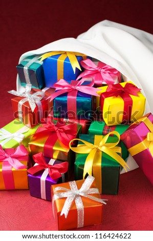 Christmas gifts bag.(vertical) White bag overflowing with Christmas gifts.