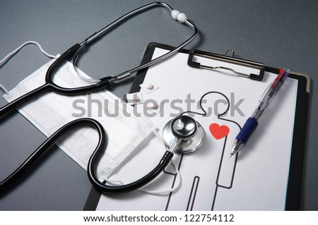 Stethoscope, mask, medicines, medical record and pen.